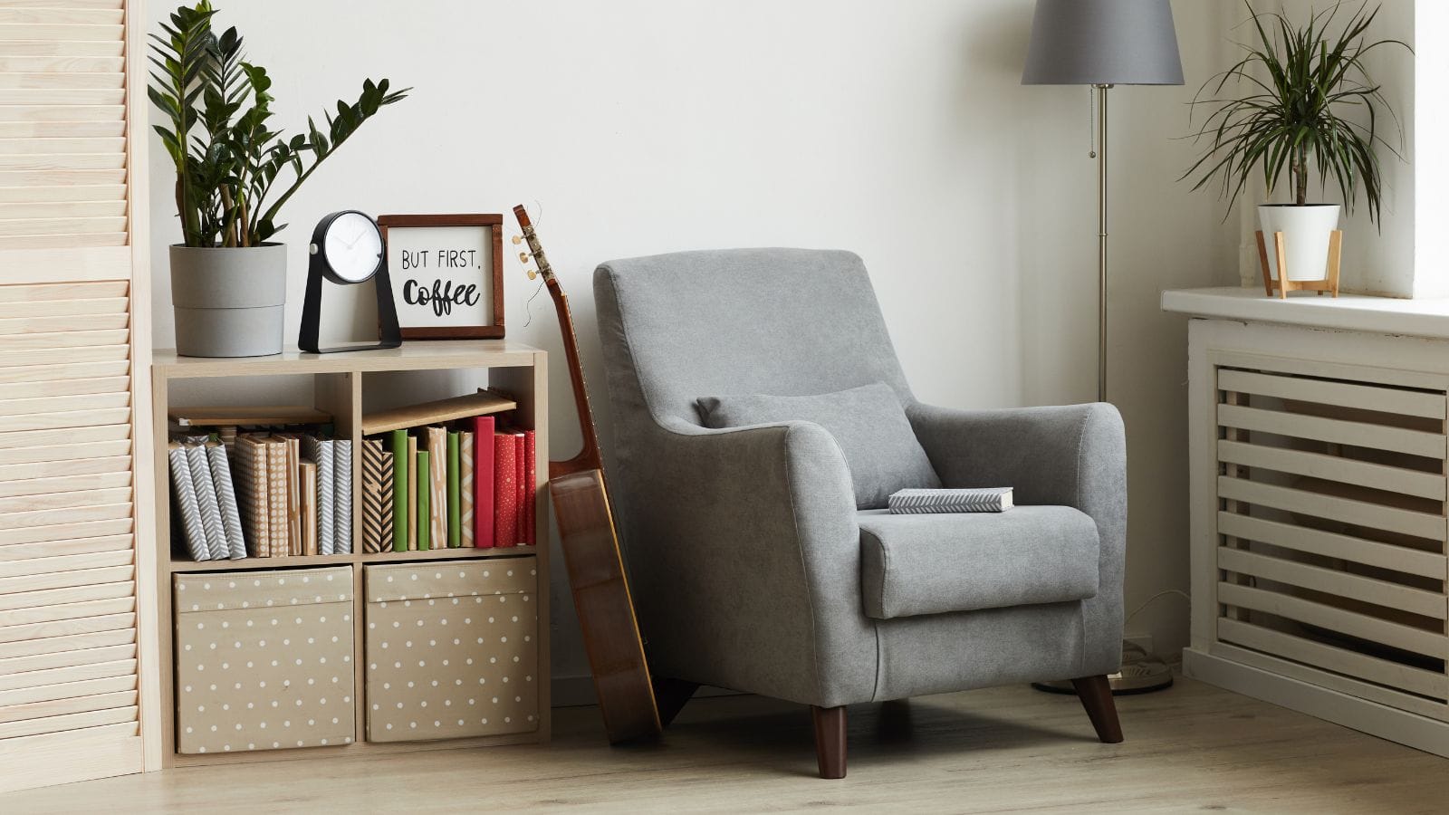 a room with a reading chair and a shelf