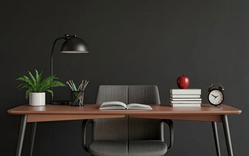 Minimalist desktop lighting featuring a black swing-arm lamp on a modern workstation