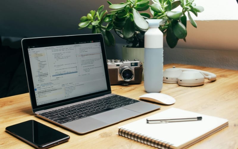 Creative diy home office desk ideas with laptop, green plants, and organized stationery in daylight