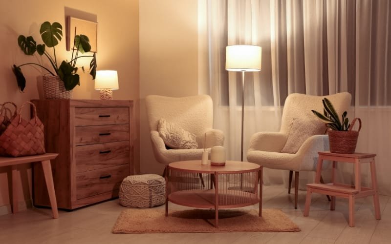 Cozy living room with beige chairs arranged around a round coffee table, ideal for family relaxation.