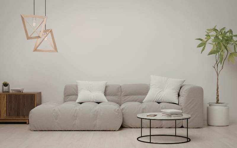 Modern living room with a beige sectional sofa, styled for minimalist apartment spaces