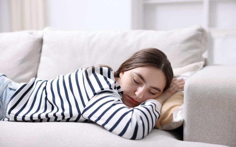 a woman sleeping on a couch