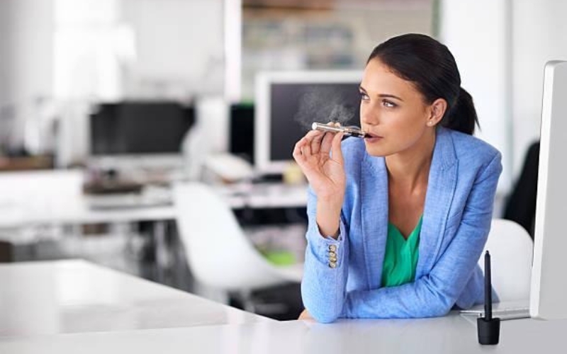 Woman smoking inside an office